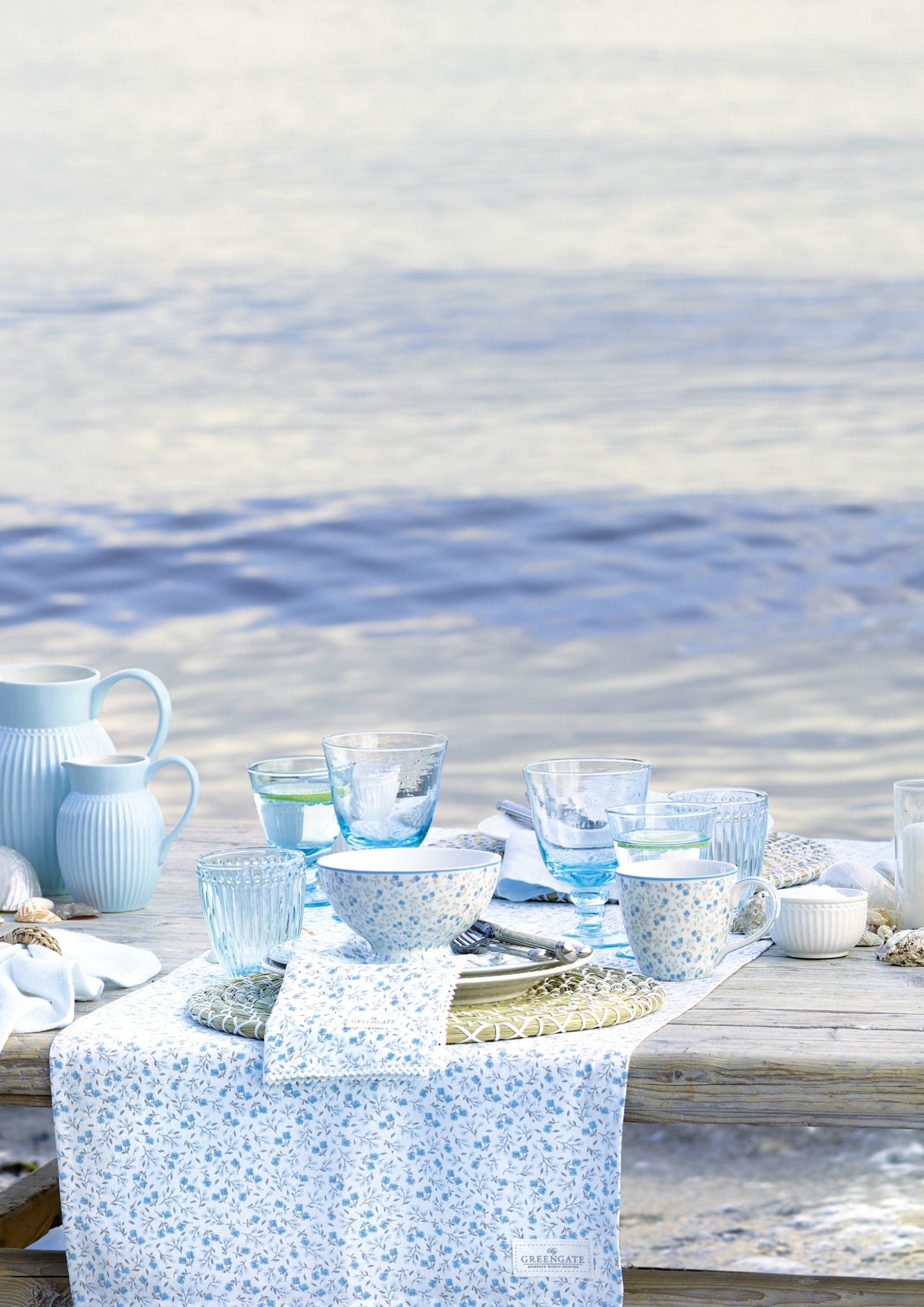 Weingläser GreenGate hellblau auf Strandtisch am Meer